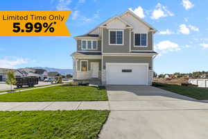 View of front facade with a garage and a front lawn