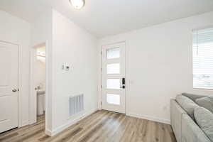 Foyer entrance with light hardwood / wood-style floors