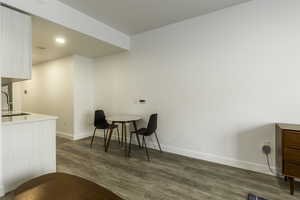 Sitting room with wood-type flooring and sink