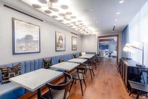 Dining space with an inviting chandelier, ornamental molding, and hardwood / wood-style flooring