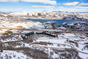 Snowy aerial view with a water and mountain view