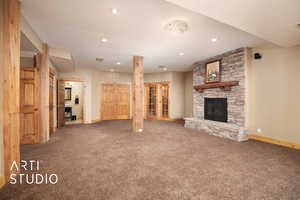 Unfurnished living room with carpet floors and a fireplace