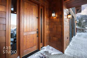 Snow covered property entrance with a mountain view