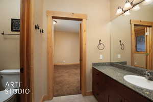 Bathroom featuring tile patterned floors, vanity, and toilet