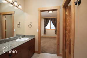 Bathroom with tile patterned floors and vanity