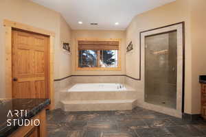 Bathroom with vanity and separate shower and tub