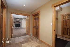 Hallway featuring light colored carpet