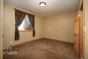 Unfurnished room with carpet floors