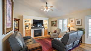 Main level great room with lofted ceiling, and tiled fireplace