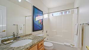 Main level Full bathroom featuring vanity,  shower combination, and toilet