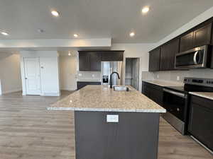 Flagstone colored cabinets, Single bowl sink,Refrigerator Included