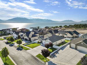 Birds eye view of property featuring a water and mountain view