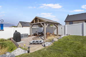 View of yard featuring a fire pit, a mountain view, and a gazebo