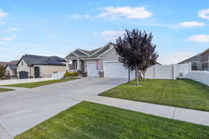 View of front of home with a garage and a front yard