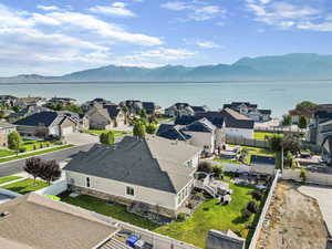 Birds eye view of property featuring a water and mountain view