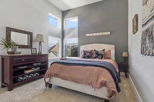 Bedroom featuring light colored carpet