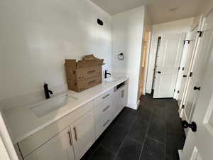 Bathroom featuring tile patterned flooring and sink