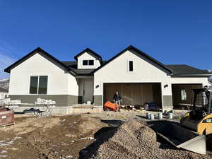 Back of property featuring a garage