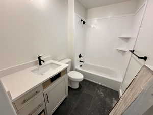 Full bathroom featuring vanity, shower / washtub combination, and toilet