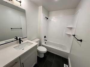 Full bathroom featuring shower / tub combination, vanity, toilet, and tile patterned flooring