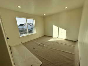 Unfurnished room featuring carpet