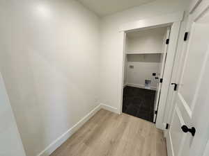 Clothes washing area with light wood-type flooring and hookup for a washing machine