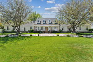 Cape cod-style house with a front lawn