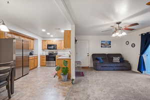 Kitchen featuring ceiling fan, sink, light brown cabinets, and appliances with stainless steel finishes