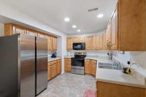 Kitchen with sink and appliances with stainless steel finishes