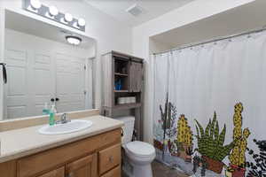 Bathroom featuring vanity and toilet