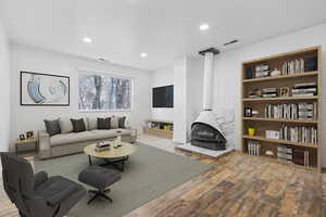 Living room featuring built in shelves and light hardwood / wood-style flooring