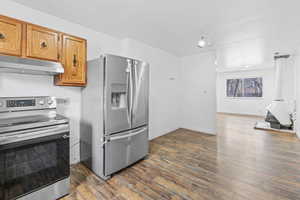 Kitchen featuring dark hardwood / wood-style floors and appliances with stainless steel finishes