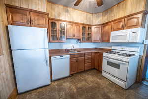 Kitchen with ceiling fan, sink, and white appliances