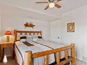 Bedroom with ceiling fan and carpet