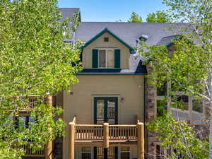 Back of property featuring a deck and french doors