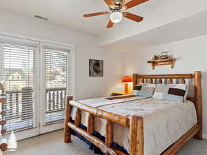 Bedroom with carpet, ceiling fan, and access to outside