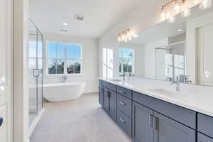 Bathroom featuring tile patterned flooring, vanity, and independent shower and bath