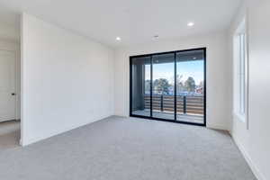 Carpeted empty room featuring a healthy amount of sunlight