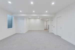 Basement with light carpet