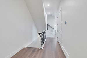 Stairs featuring wood-type flooring