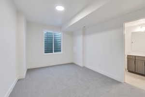 Unfurnished room featuring light colored carpet