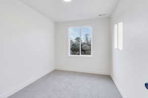 Unfurnished room featuring carpet flooring