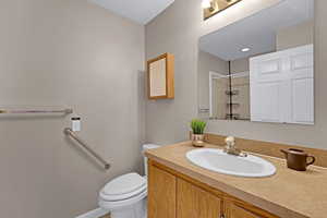 Master bathroom featuring walk in shower, vanity, and toilet