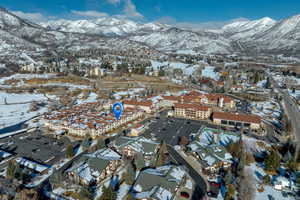 Snowy aerial view featuring a mountain view