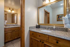 Bathroom with tile patterned flooring and vanity