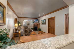 Dining room featuring carpet flooring and crown molding