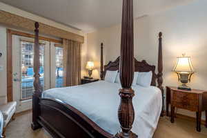 Bedroom featuring light carpet