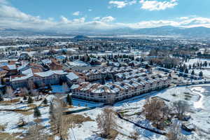 Snowy aerial view featuring a mountain view