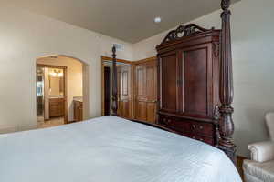 Tiled bedroom with ensuite bathroom and a closet