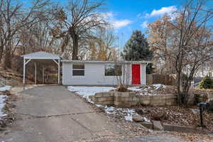 View of front of house with a carport